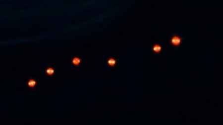 Group of flying yellow lights